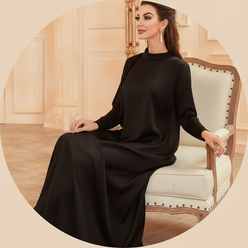 Circular portrait of influencer Dina Taji, smiling gently, wearing a royal black AMIRA abaya set against a clean, warm cream 